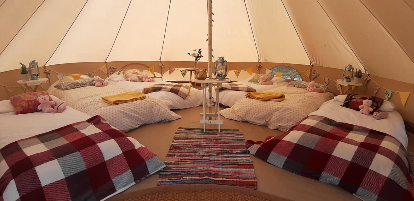 Bell tent bedroom with colourful bedding