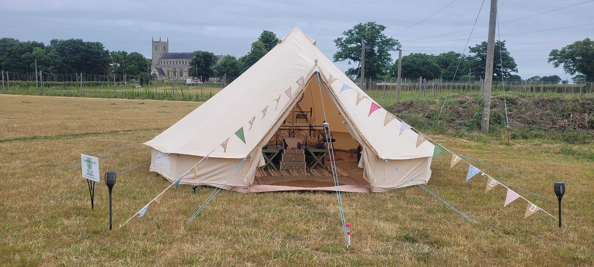 Single bell tent pitched in the countryside