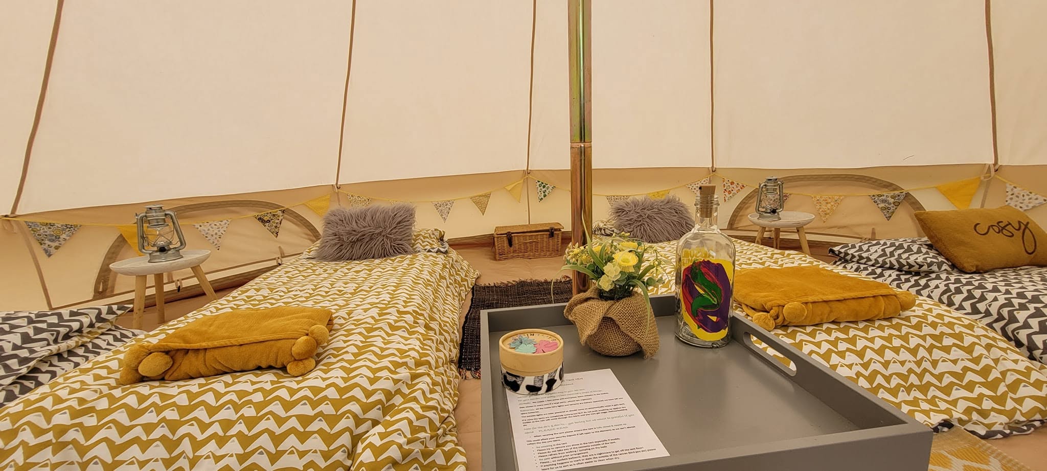 Furnished bell tent with decorative bedding