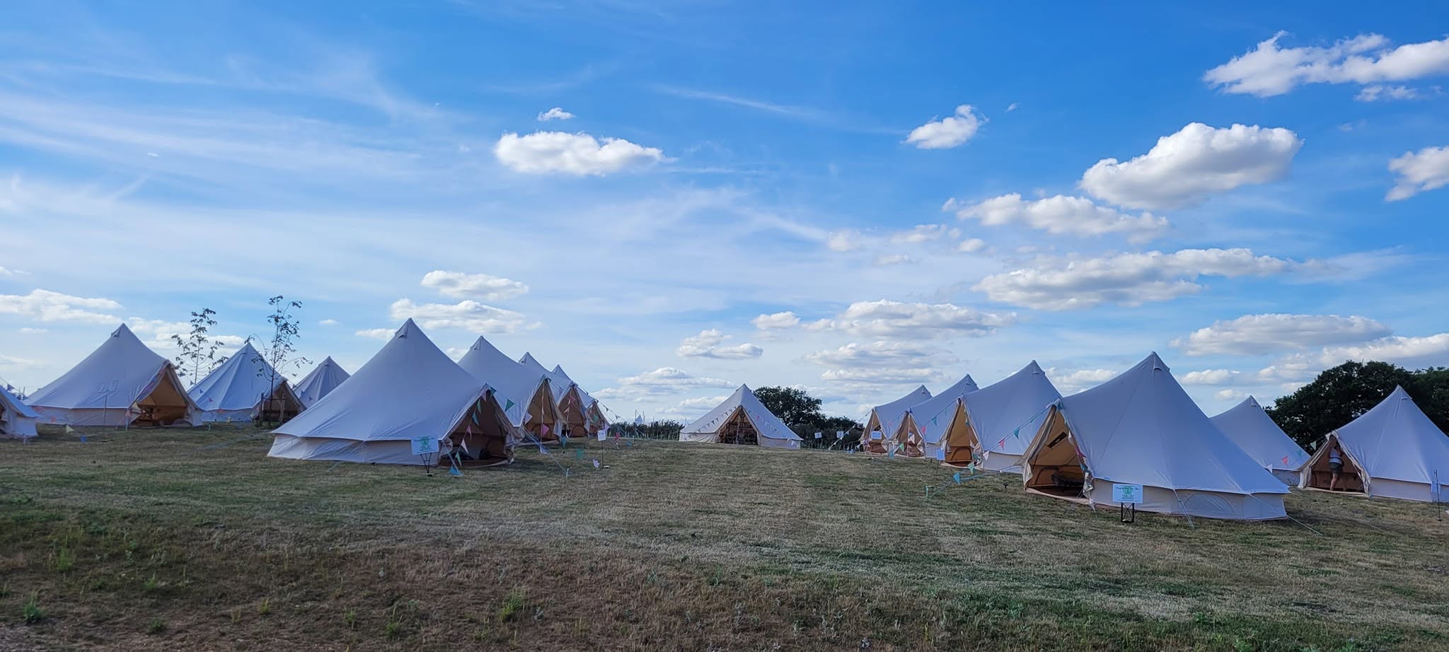 Bell tents arranged together in the countryside